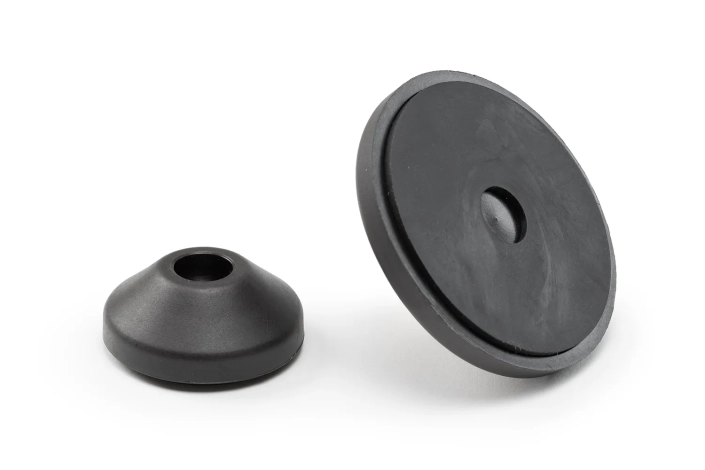 Two black leveling foot bases of different sizes, arranged on a neutral background.