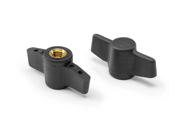Two black fixing knobs with bushing arranged on a neutral background.