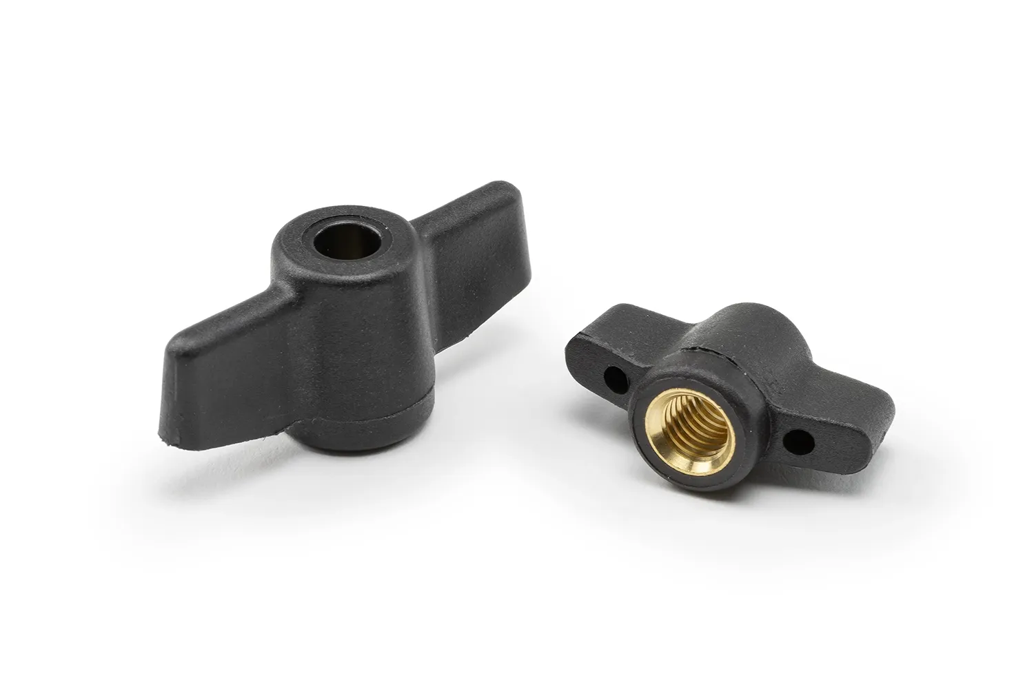 Two black wing nut fasteners with bushing and through hole arranged on a neutral background.