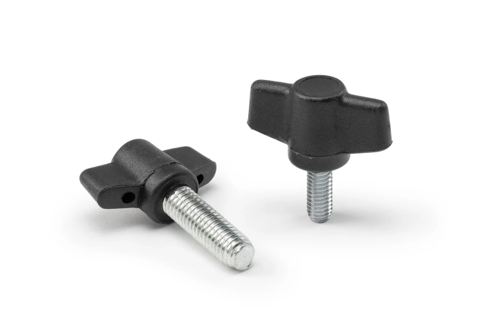Two black fastening wing nuts with stud arranged on a neutral background.