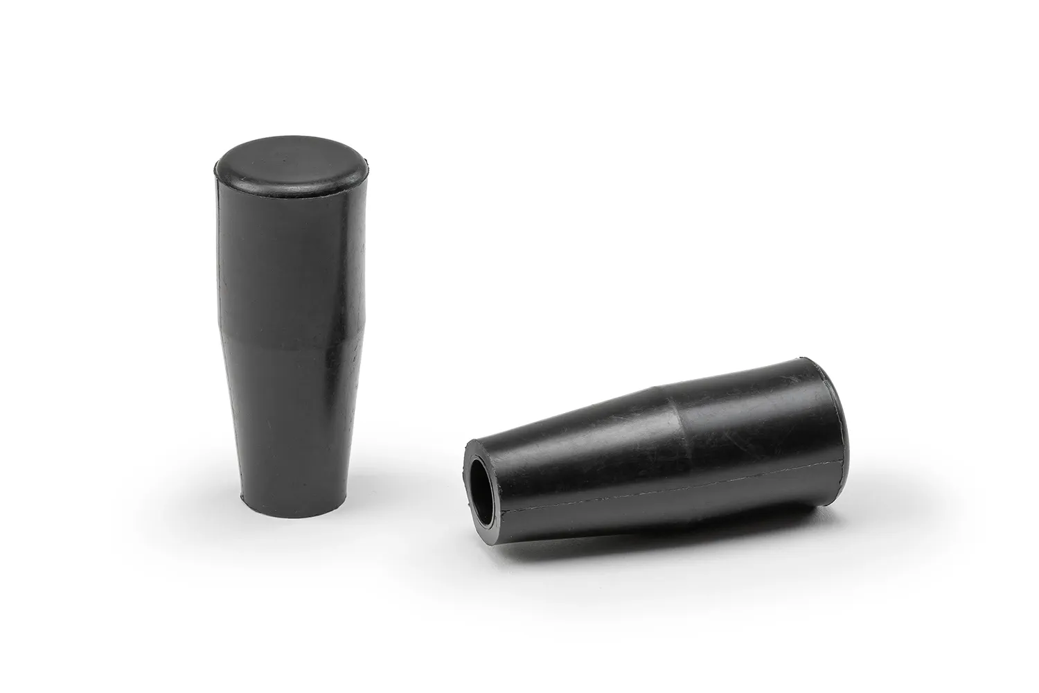 Two black conical handles arranged on a neutral background.