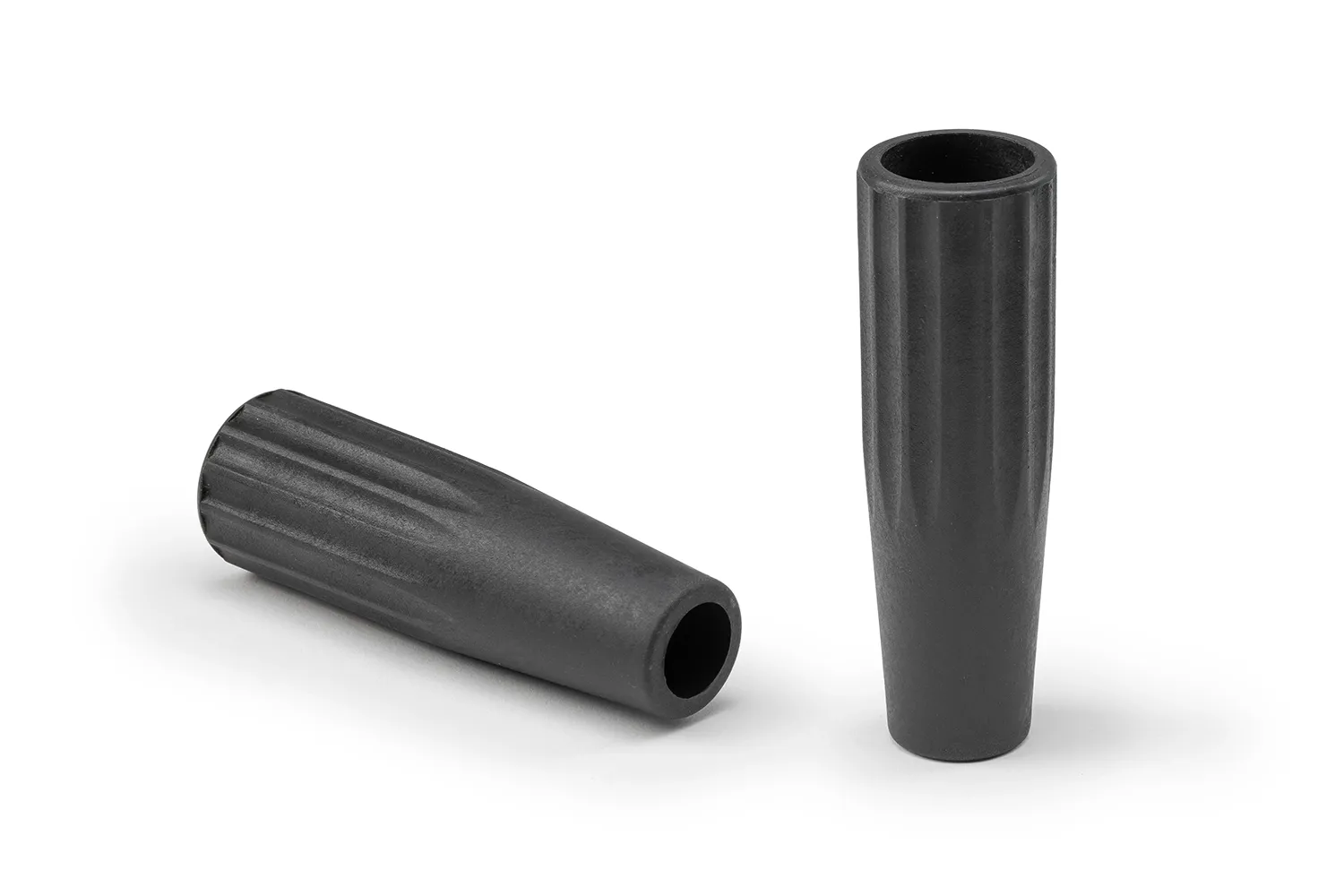 Two black conical grips with through holes arranged on a neutral background.