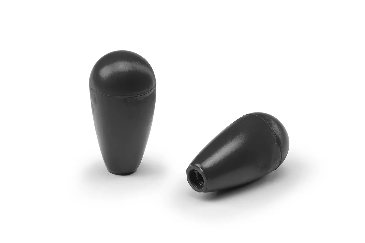 Two black conical handles arranged on a neutral background.