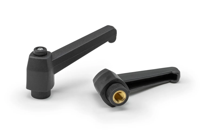Monplast-Indexing-Levers Two black indexing levers with bushing arranged on a neutral background.