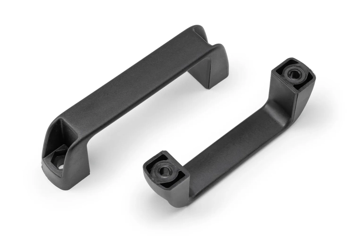 Two black plastic handles with through holes seen from above, arranged on a neutral background.