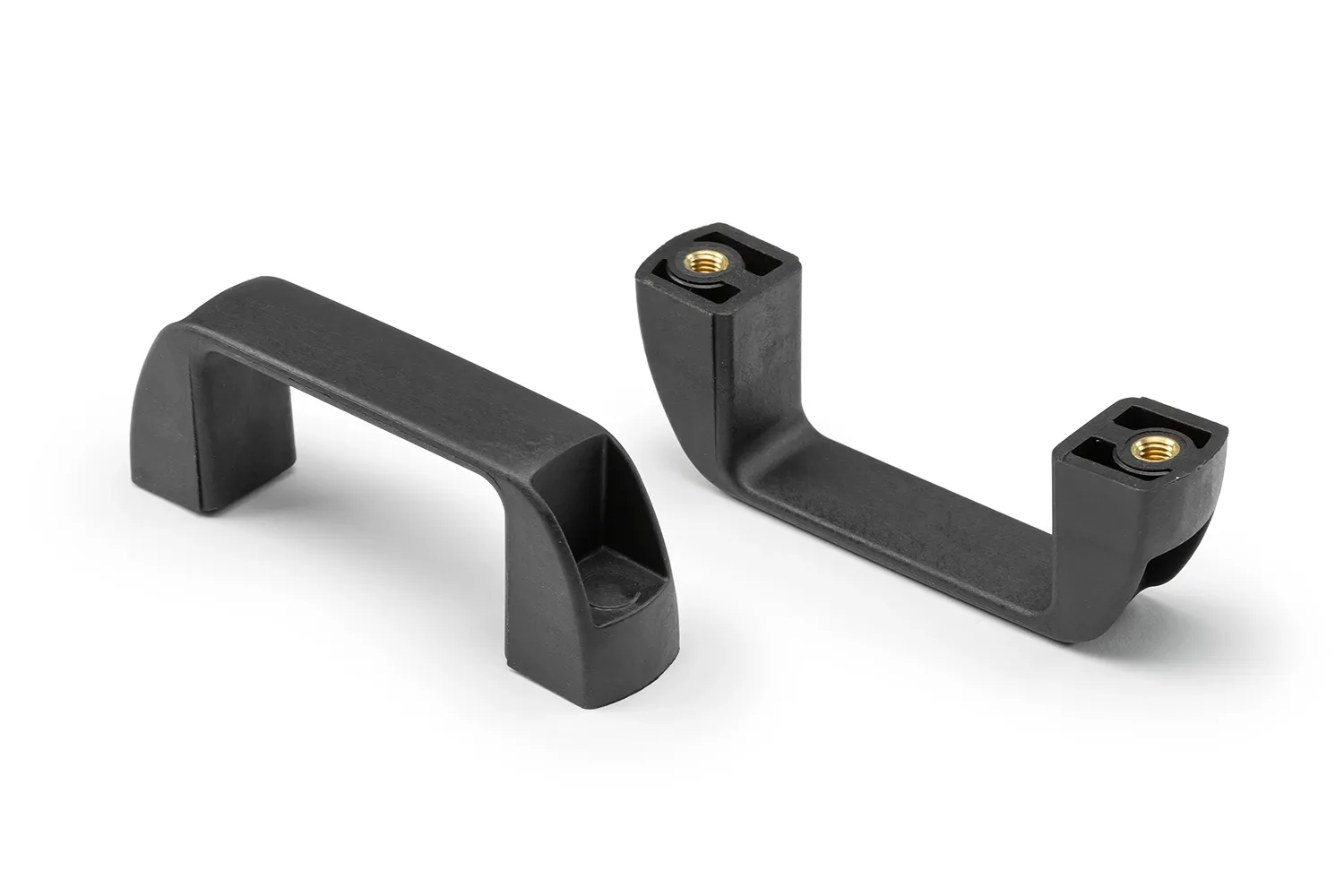 Two black plastic handles with bushing arranged on a neutral background.