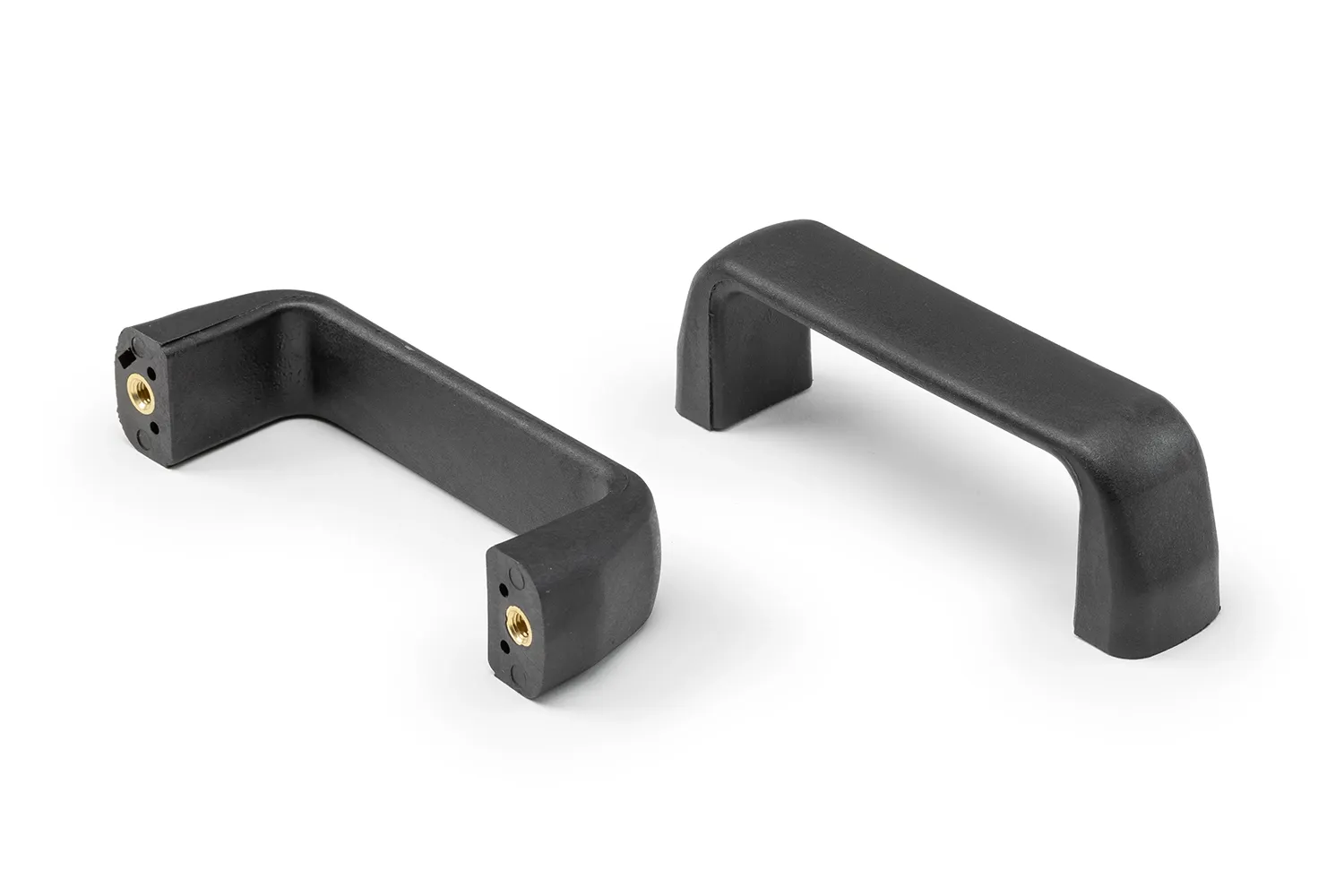 Two black plastic handles with bushing arranged on a neutral background.