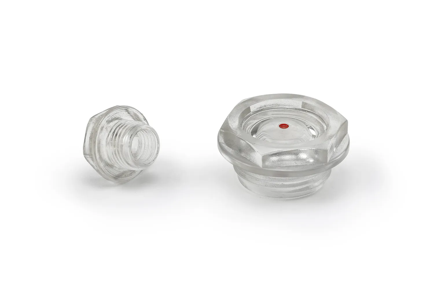 Two transparent oil level sight plugs of two different sizes, arranged on a neutral background.