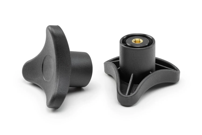 Two black 3-point handwheels with bushing arranged on a neutral background.