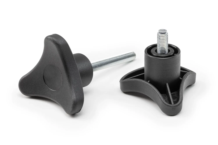 Two black 3-lobe handwheels with studs of different sizes, arranged on a neutral background.