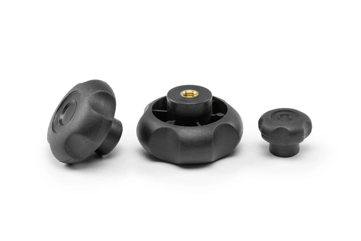 Three black 5-lobe handwheels with bushings, in different sizes, arranged on a neutral background.