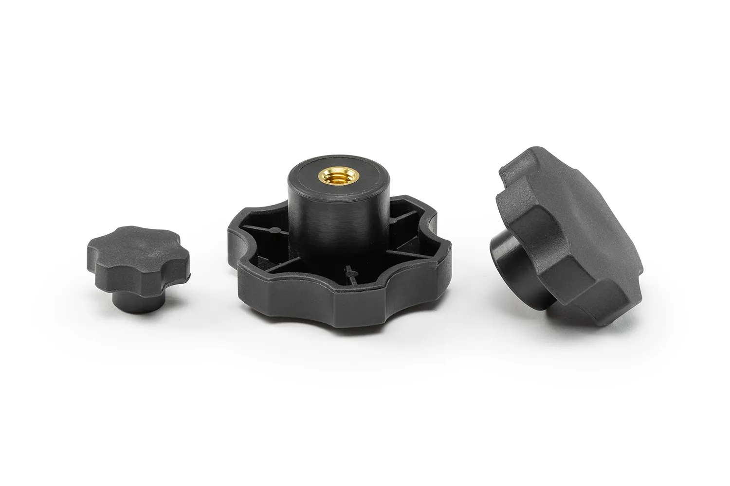 Three black 6-lobe handwheels with bushings, in different sizes, arranged on a neutral background.