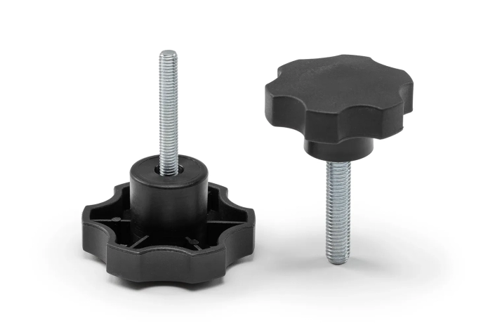 Two black 6-lobe knobs with pin arranged on a neutral background.