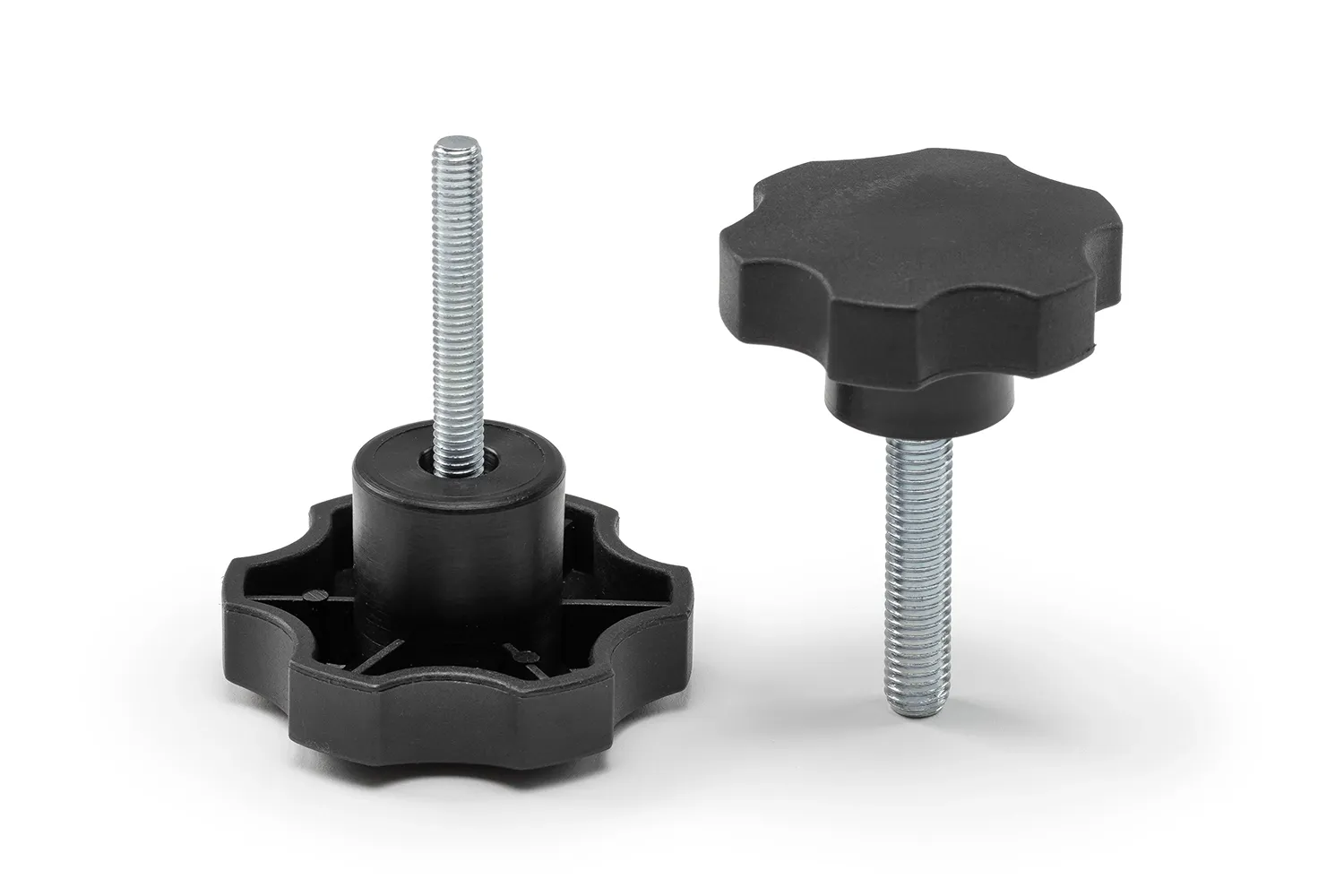 Two black 6-lobe knobs with pin arranged on a neutral background.